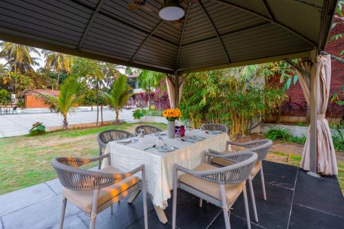 a table and chairs under a large umbrella at Treat Beach Resort in Bordi