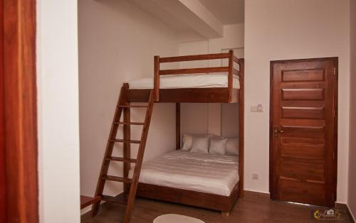 a room with two bunk beds and a ladder at Pensive Villa in Nuwara Eliya