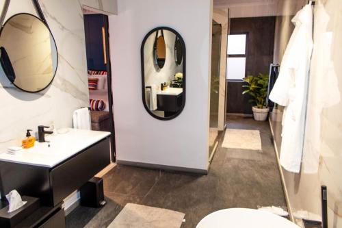 a bathroom with a sink and a mirror at Forty 4 On Hoog in Polokwane
