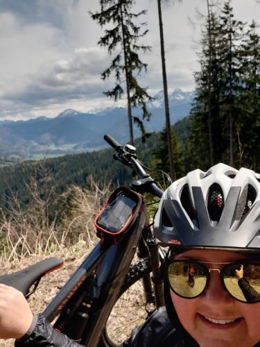 a woman with a helmet and glasses on a bike at Ferienhaus Akogelblick in Landl