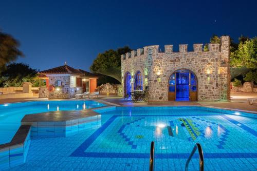 una piscina frente a un castillo por la noche en Casa Loma, en Trianta