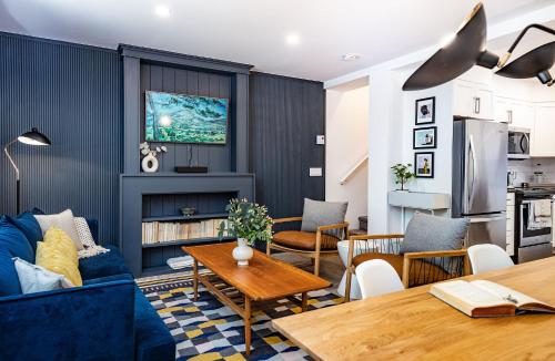 a living room with a blue couch and a table at Revelation Retreat by Revelstoke Vacations in Revelstoke