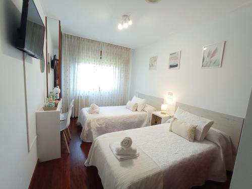 Ένα ή περισσότερα κρεβάτια σε δωμάτιο στο Martínez Rooms Pilgrims