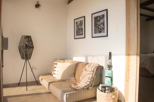 a living room with a couch and a lamp at Terramia Estate in Minca