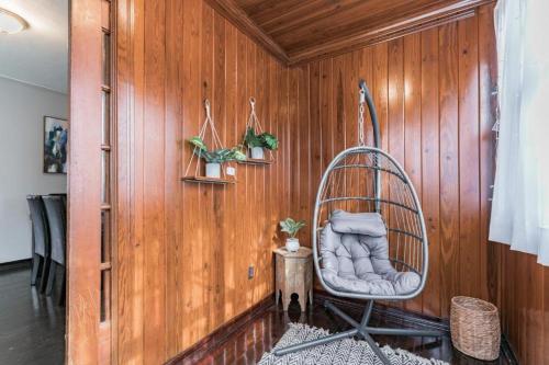 a room with a rocking chair in a wooden wall at Comfy pet friendly home in Jacksonville mins to downtown’s in Jacksonville