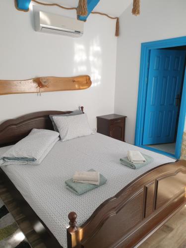 a bedroom with a bed with two towels on it at Casa Anica in Sulina
