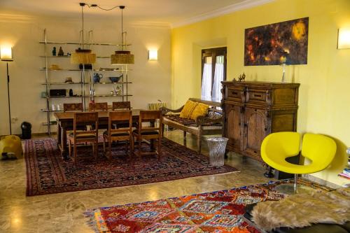 a living room with a table and a dining room at Finca Olivar in Gaucín