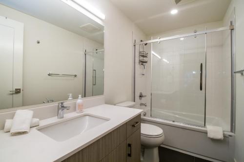 a bathroom with a sink and a shower and a toilet at Magog Condo by Revelstoke Vacations in Revelstoke