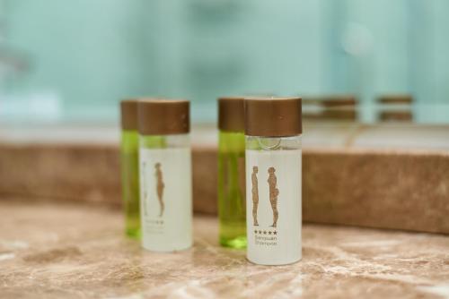 Tres botellas de aceites esenciales sobre un mostrador. en Apartment by the river, en Tiflis