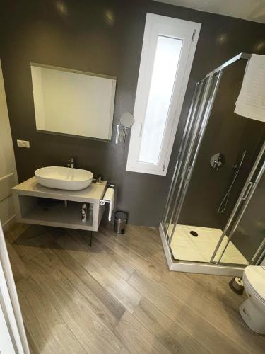 a bathroom with a glass shower and a sink at Padua Suite in Padova