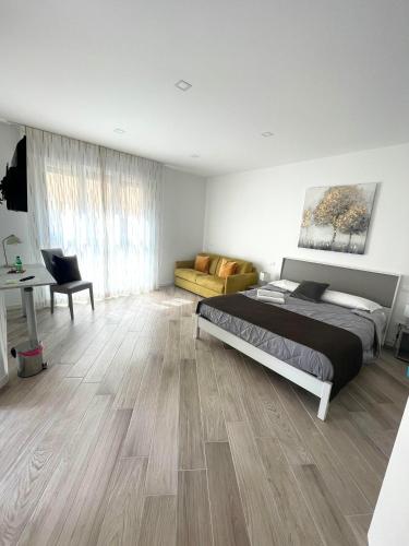 a bedroom with a bed and a desk and a couch at Padua Suite in Padova