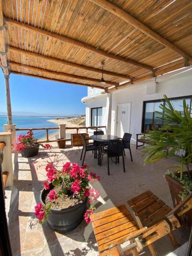 a patio with a table and chairs and the ocean at Villa Paraíso in La Ventana