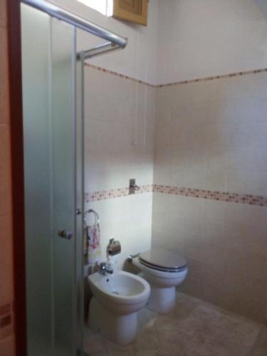 a bathroom with a toilet and a sink at Apartment A&M in Marsala