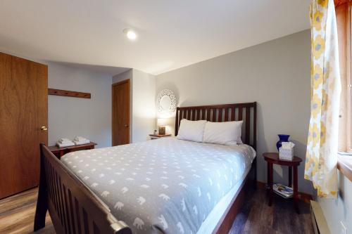 a bedroom with a large bed and a window at New England Treasure in North Conway