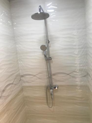 La salle de bains est pourvue d'une douche avec un pommeau de douche. dans l'établissement Sitora Star guest house, à Samarcande