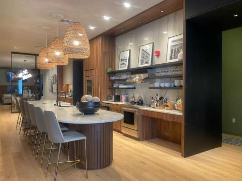 a kitchen with a large island with a table and chairs at Kinn Guesthouse Downtown in Milwaukee