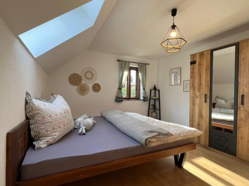 a bedroom with a bed with purple sheets and pillows at Chalupa U Dvořáků in Lomnice nad Lužnicí