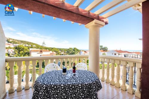 a table on a balcony with a view of the ocean at Apartamentos Madeira Casa Azahar in Alcossebre