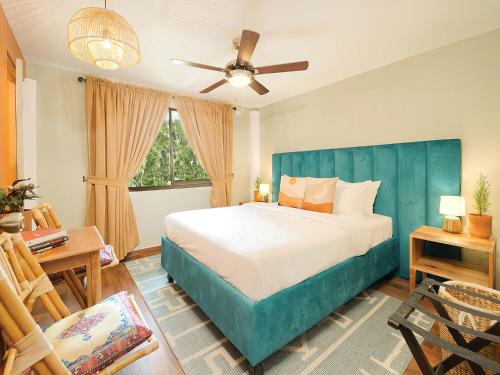 a bedroom with a large bed with a blue headboard at Selina Boquete in Boquete