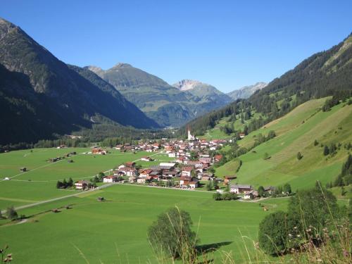 a small village in a valley in the mountains at Panorama-Hotel Winklerhof in Holzgau