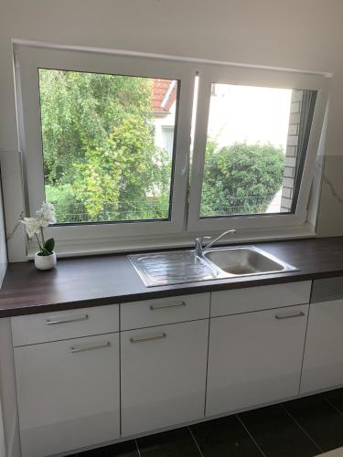 a kitchen with a sink and a window at AT-Rooms in Hannover