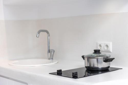 a pot on top of a stove in a kitchen at Krina Mare Boutique Hotel in Naxos Chora