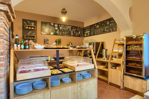 a bakery with a counter with food on it at Hotel Kanajt in Punat