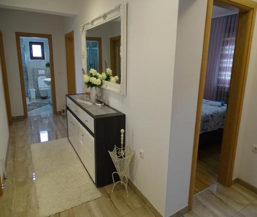 a bathroom with a dresser and a mirror at Holiday house Rončević 50 m from sea A1 in Jasenice