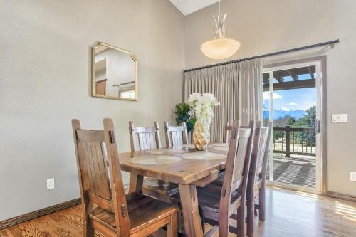 a dining room with a table and chairs and a mirror at NEW 5BR House with Peak Views in Colorado Springs in Colorado Springs