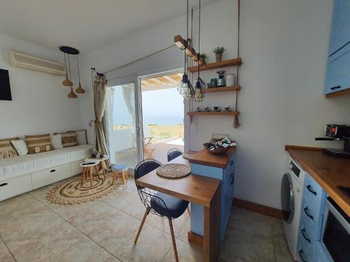 a kitchen with a table and chairs in a room at Tramonto Luxury Villa No1- Breathtaking sunset view in Karpathos Town