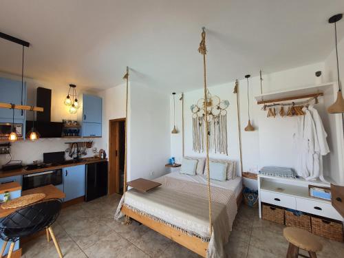a bedroom with a swinging bed in a room at Tramonto Luxury Villa No1- Breathtaking sunset view in Karpathos Town