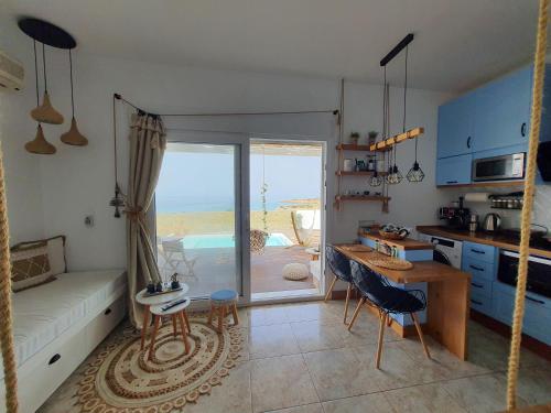 a kitchen and living room with a view of the ocean at Tramonto Luxury Villa No1- Breathtaking sunset view in Karpathos Town
