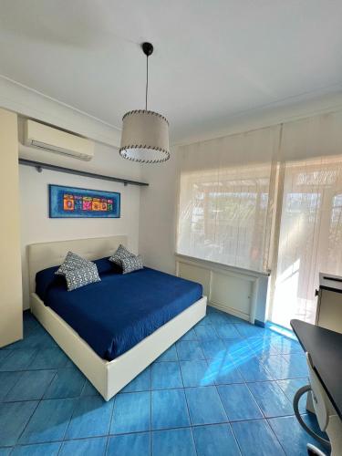 Schlafzimmer mit einem Bett und blauem Boden in der Unterkunft Augusto Capri Apartment in Capri