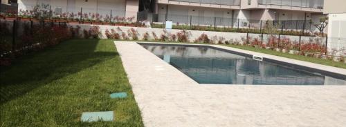 a swimming pool in a yard next to a building at Apartment Lake Garda in Garda