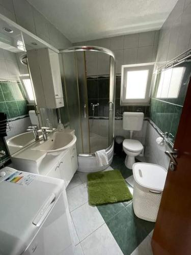a bathroom with a sink and a toilet and a shower at Apartments Ana Kroatien Vodice in Vodice