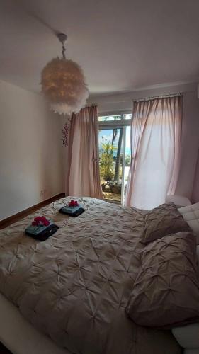 a bedroom with a large bed with two plates on it at Villa Bounty - amazing ocean view in Punaauia