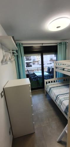 a room with two bunk beds and a window at Rota Mar in Rota