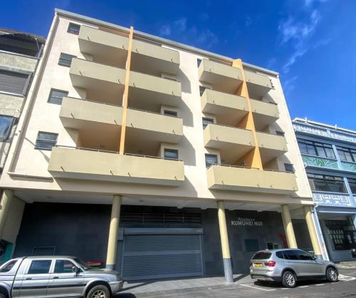 a building with balconies on the side of it at Recent Bel Appartement une chambre Papeete in Papeete