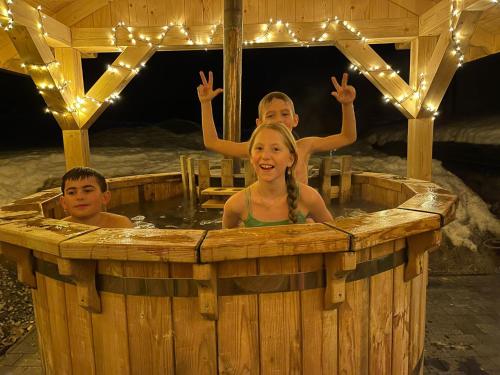 a group of children in a hot tub with lights at Willa Zaolzie in Istebna