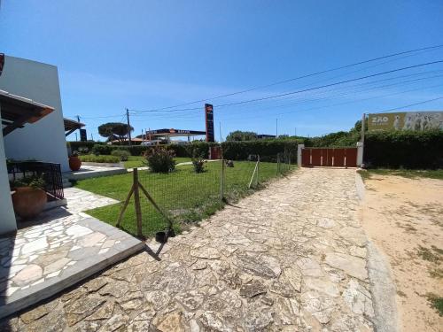 a dirt road next to a house with a fence at Cool Villas T2 in Sagres