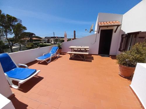 a patio with two chairs and a table on a building at Cool Villas T2 in Sagres