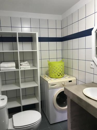 a bathroom with a washing machine and a washer at A Cabana in Angra do Heroísmo