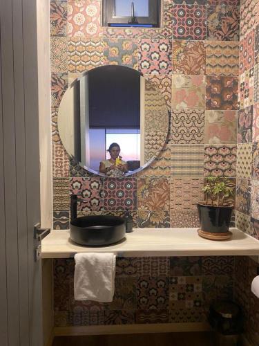 a person taking a picture in a bathroom mirror at Ventana Al Mar in Pichilemu