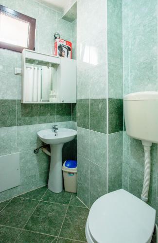 a bathroom with a toilet and a sink at Apartments MaXhit in Tivat