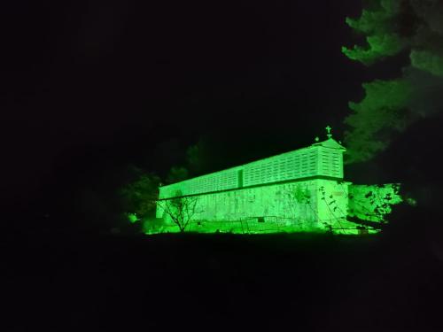 a building with green lights on it at night at Casa do Lucio in Rianjo