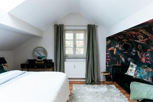 a bedroom with a large white bed and a window at Maisonette Ahornhöhe in Kempten