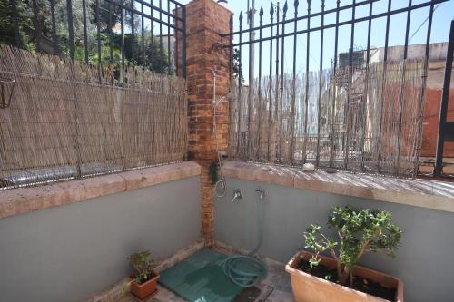a balcony with plants and a fence and a toilet at PALAZZO PELLEGRINO vietri in Vietri sul Mare