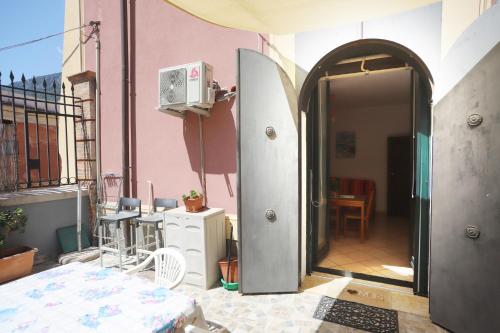 an open door to a balcony of a pink building at PALAZZO PELLEGRINO vietri in Vietri sul Mare