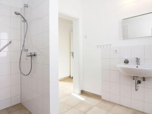 a white bathroom with a shower and a sink at Ferienhaus, Boiensdorf in Boiensdorf
