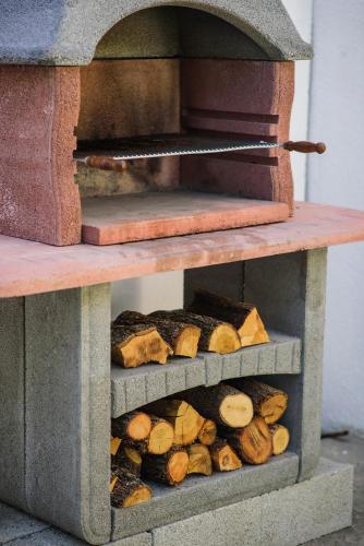 a wood fired oven with a bunch of food inside at Aurora Seaview Apartment in Mlini